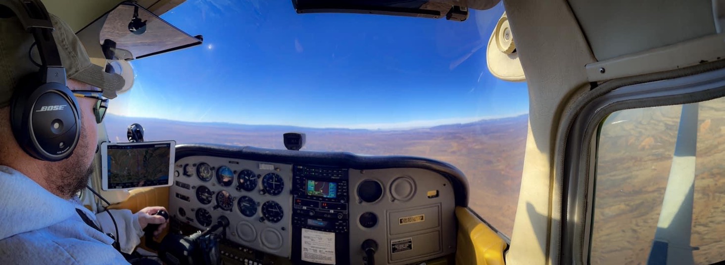 Matthew Cox flying, instrument panel and Four Corners terrain ahead.